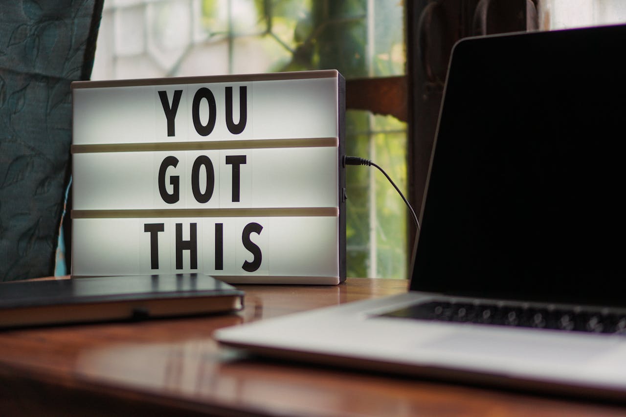 our-services-3 Lit sign with 'You Got This' alongside laptop on office desk.