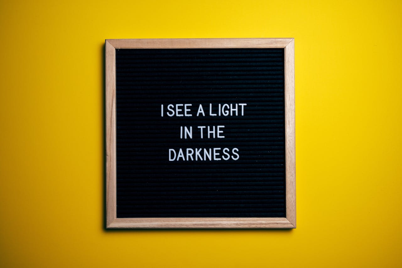 gallery-5 Black letterboard with a motivational quote on a vibrant yellow background.